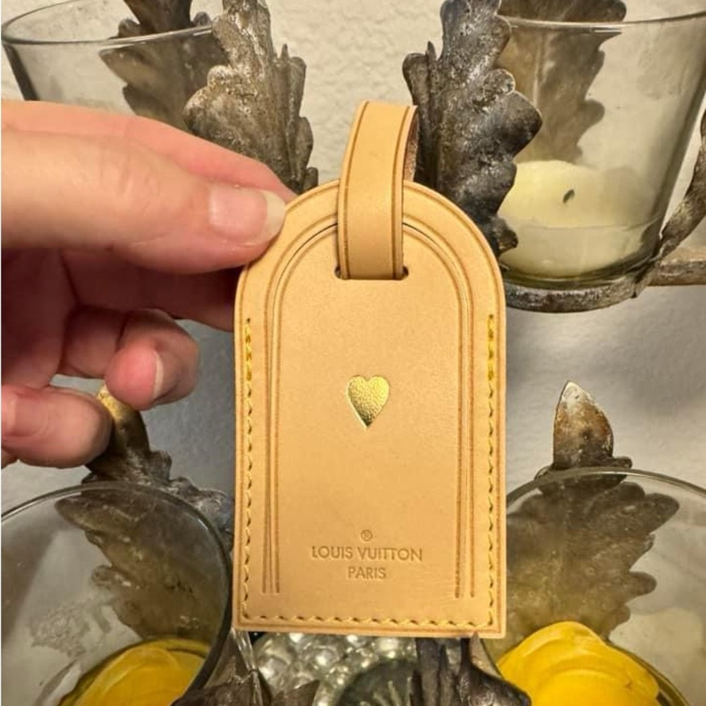 Louis Vuitton luggage tag stamped with gold heart.   Never used.